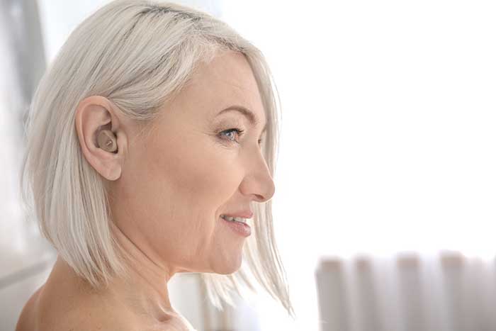 Woman with Hearing aid in ear
